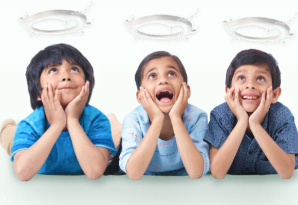 Three happy kids looking up